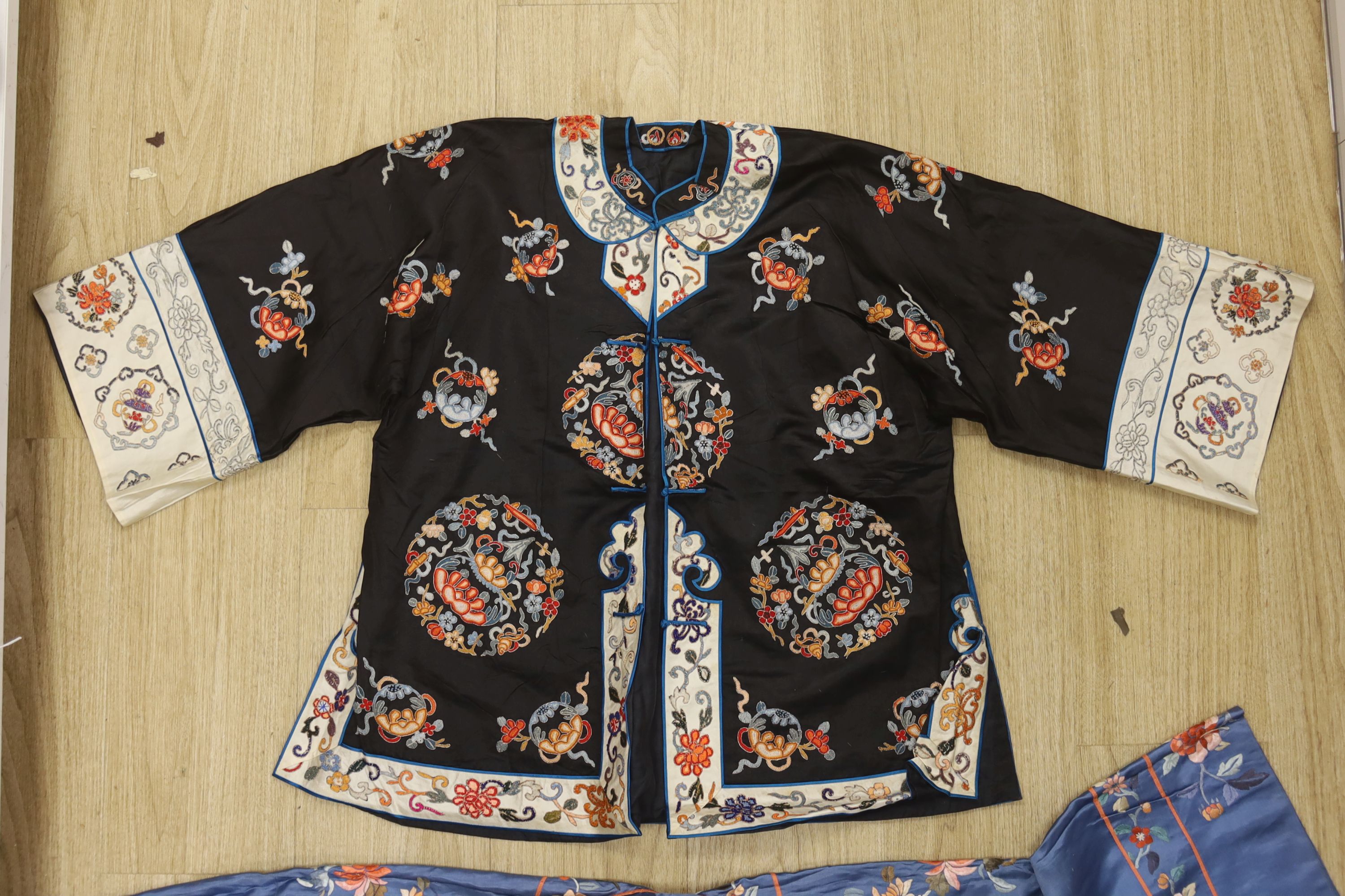 A 1930's Chinese embroidered jacket, embroidered with dragons and a black silk embroidered jacket with Chinese knotting